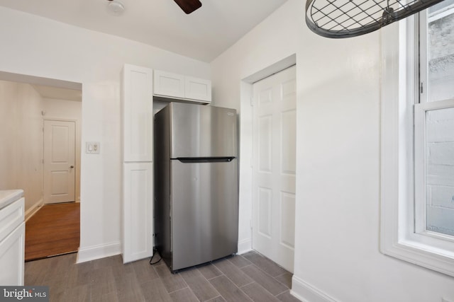 kitchen featuring white cabinets, ceiling fan, stainless steel refrigerator, and dark hardwood / wood-style floors