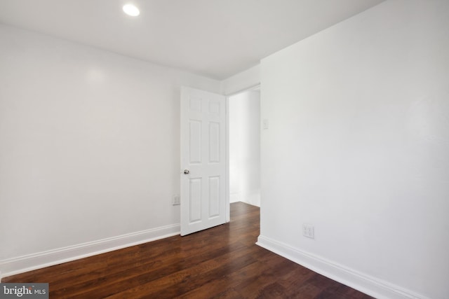 empty room featuring dark hardwood / wood-style flooring