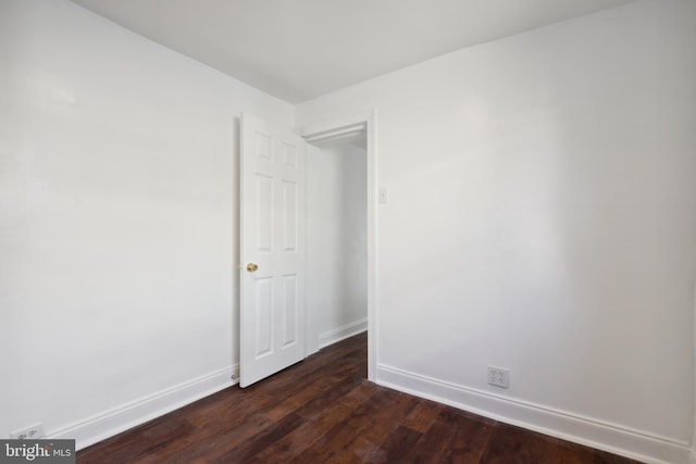 empty room with dark hardwood / wood-style floors