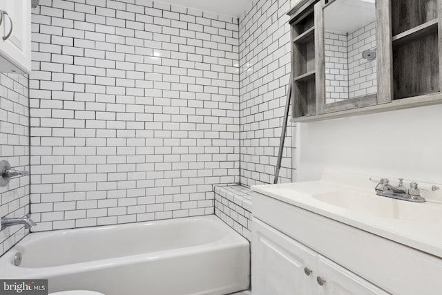 bathroom with tiled shower / bath combo and large vanity