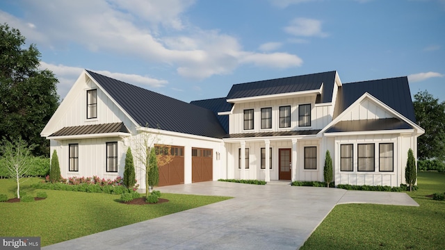 modern farmhouse featuring a front yard and a garage