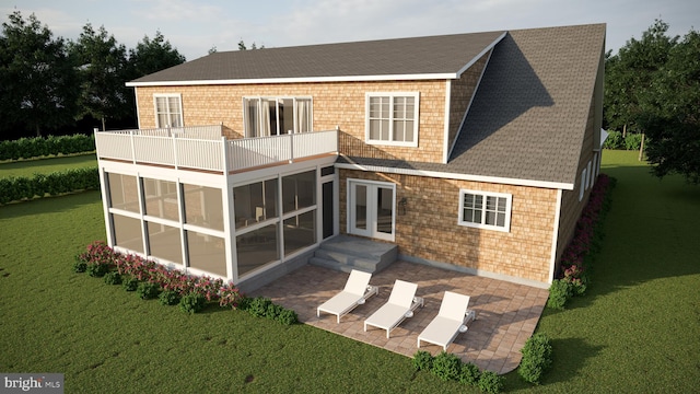 rear view of house featuring french doors, a sunroom, a lawn, and a patio