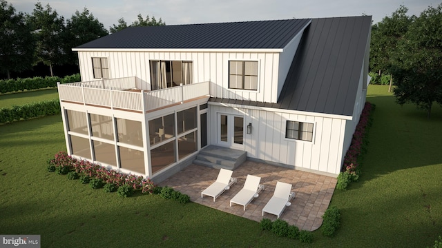 rear view of property with a sunroom and a yard