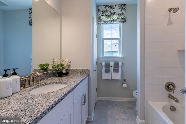 full bathroom with tiled shower / bath, toilet, tile floors, and large vanity