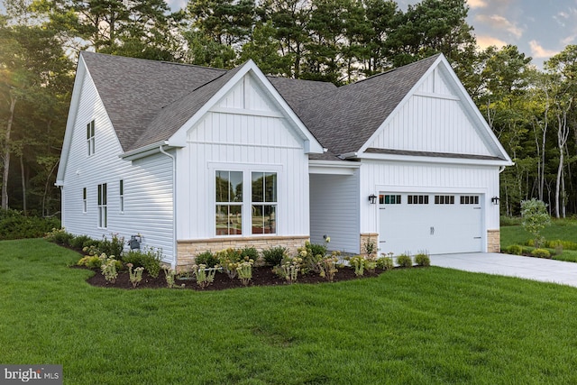 modern farmhouse featuring a lawn and a garage