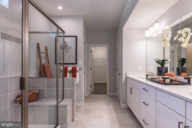 bathroom with walk in shower, tile floors, and double sink vanity