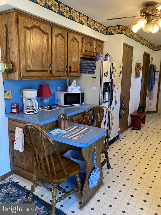 kitchen featuring light tile flooring and ceiling fan