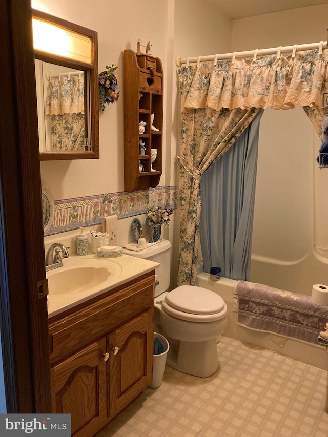 full bathroom with toilet, shower / tub combo, vanity with extensive cabinet space, and tile flooring