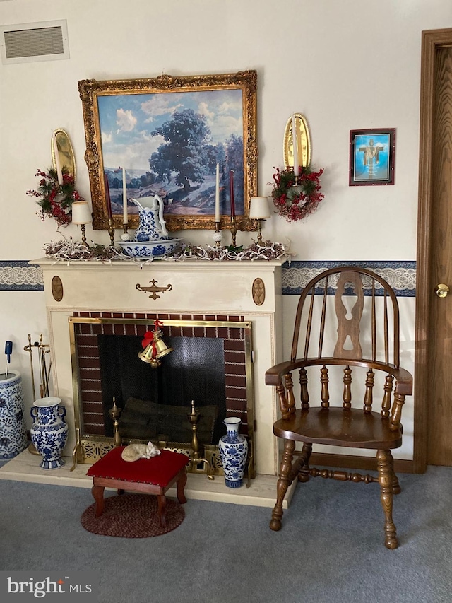 living area with carpet floors and a brick fireplace