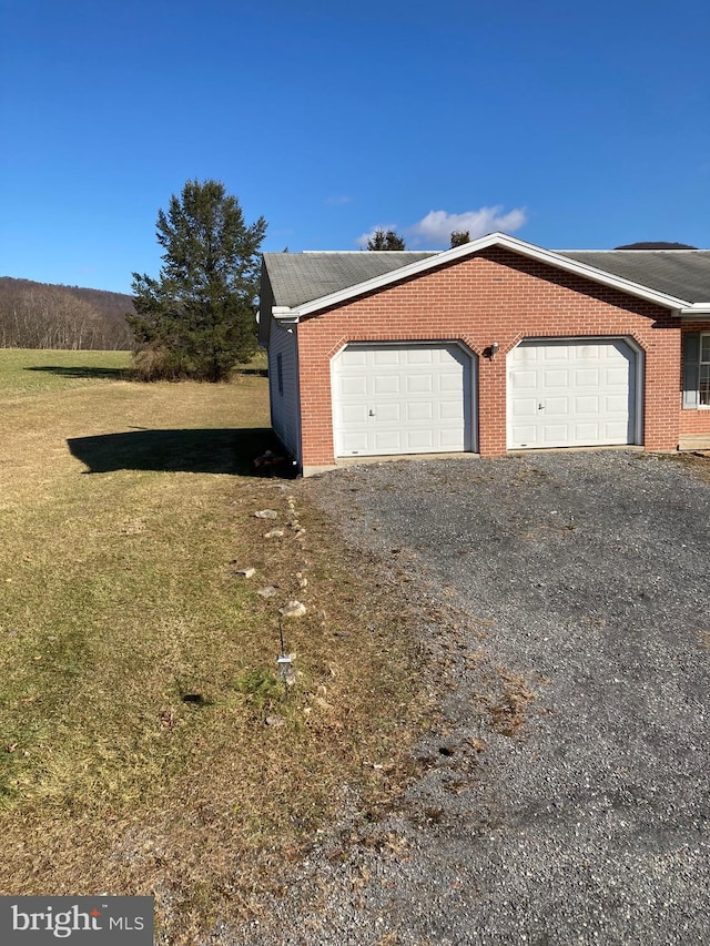 view of front of home with a front lawn and a garage