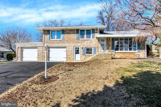 split level home with a front yard and a garage