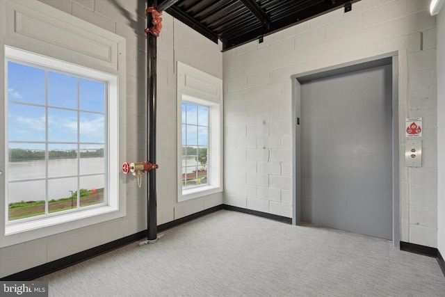 16423 River View Dr, Bristol, PA 19007 - carpeted spare room featuring a water view, concrete block wall, and elevator