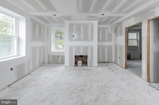 unfurnished living room with plenty of natural light