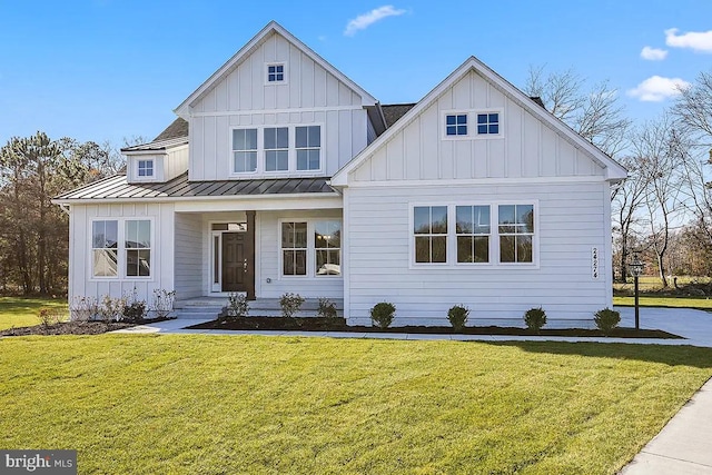 modern farmhouse featuring a front yard and covered porch