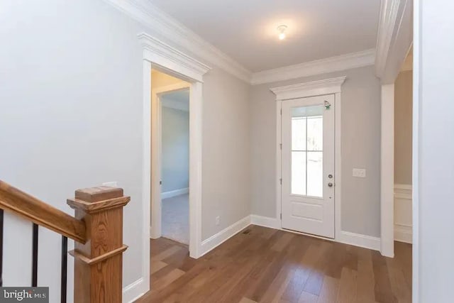 entrance foyer with ornamental molding and dark wood-type flooring