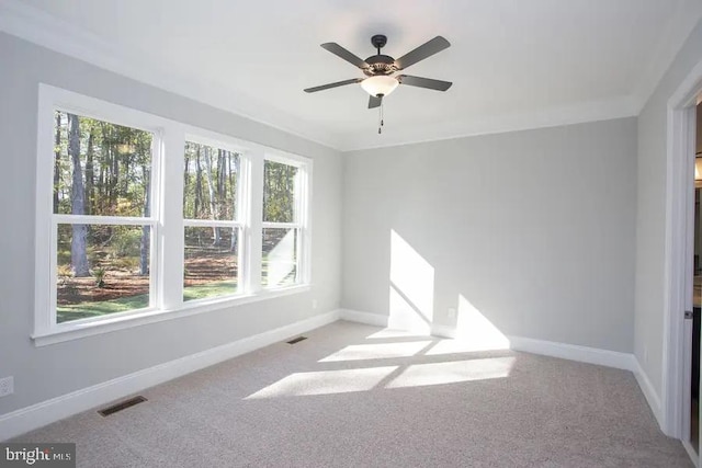 empty room featuring ceiling fan and light colored carpet