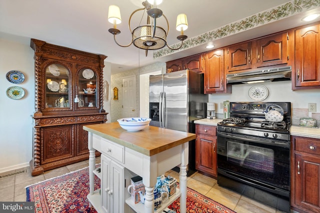 kitchen with gas stove, an inviting chandelier, stainless steel fridge with ice dispenser, and light tile floors