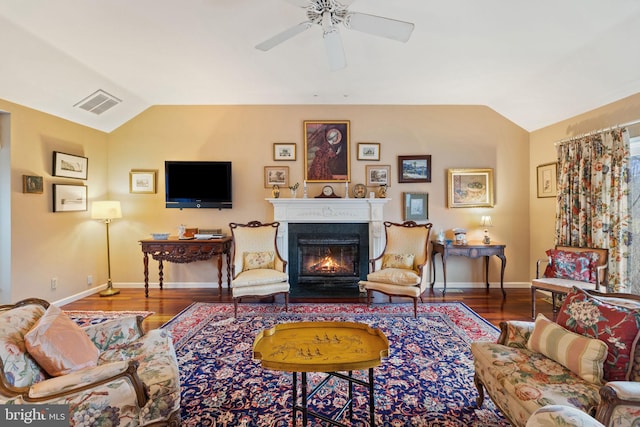 living room featuring ceiling fan, lofted ceiling, and dark hardwood / wood-style floors