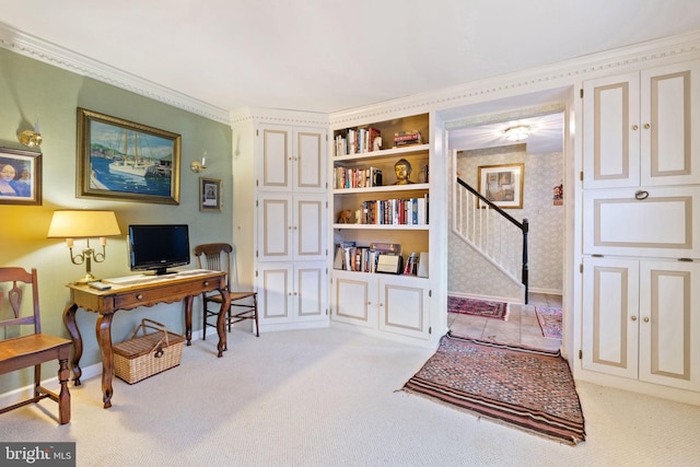 office area with built in shelves, light colored carpet, and ornamental molding