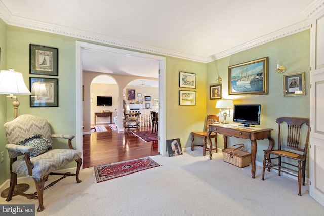 office featuring a fireplace, crown molding, and light hardwood / wood-style floors