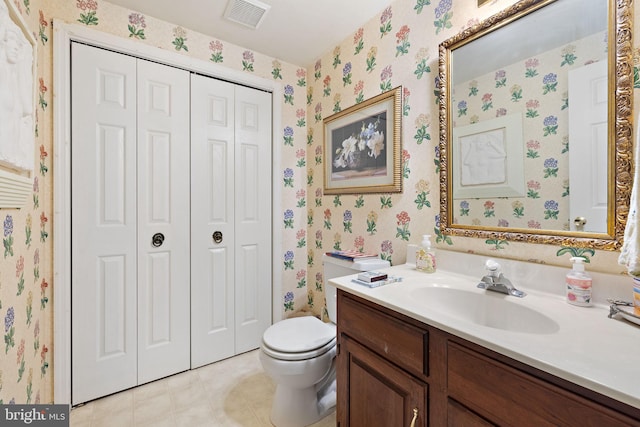 bathroom featuring vanity, tile flooring, and toilet