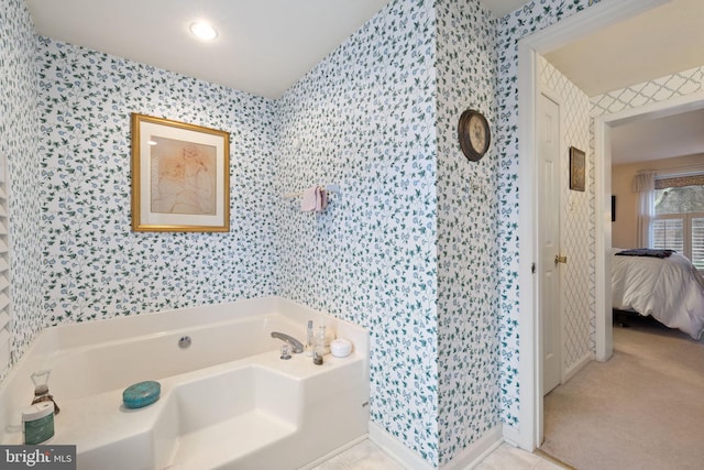 bathroom featuring tile floors and a bathtub