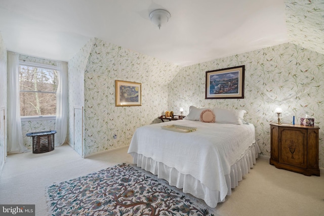 carpeted bedroom with lofted ceiling