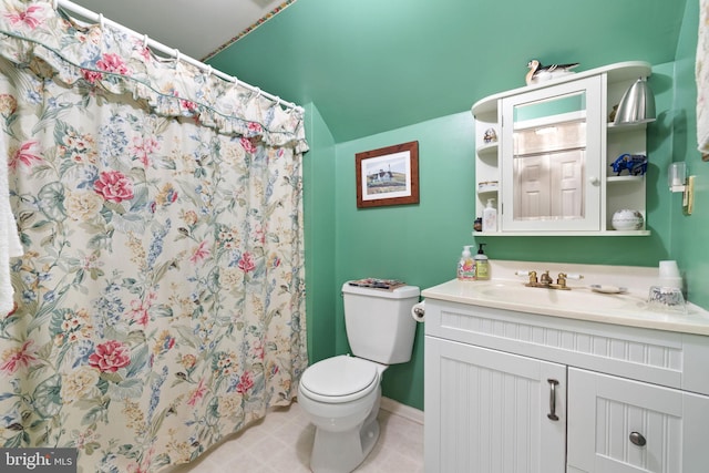 bathroom featuring vanity, tile flooring, and toilet