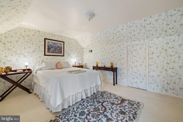 bedroom with light carpet and vaulted ceiling