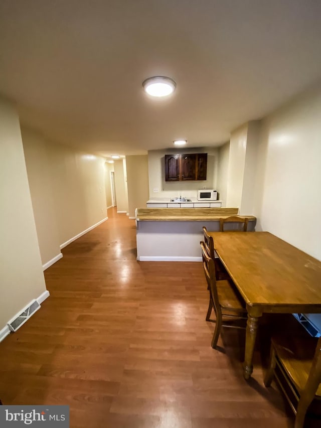 unfurnished dining area with dark hardwood / wood-style floors