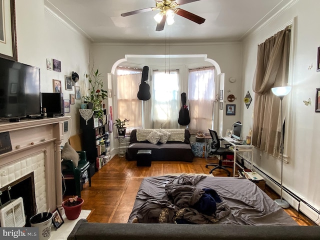 living room featuring a fireplace, ornamental molding, hardwood / wood-style floors, and ceiling fan