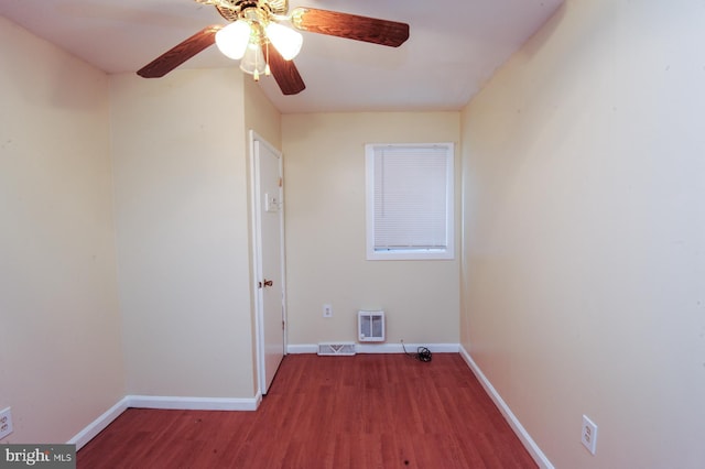 laundry area with ceiling fan and dark wood-type flooring