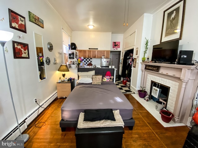 interior space with dark hardwood / wood-style floors, a fireplace, and baseboard heating