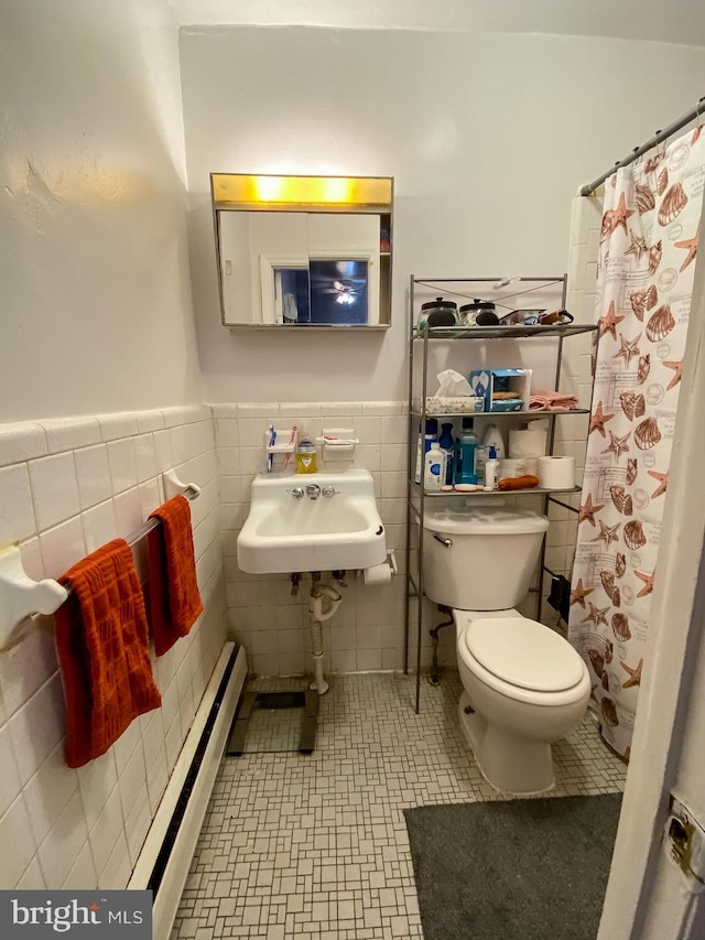 bathroom featuring toilet, tile walls, tile flooring, and a baseboard heating unit