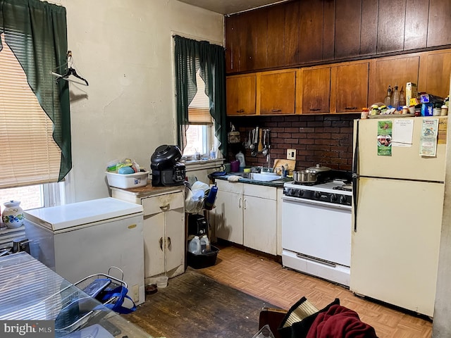 kitchen featuring white appliances and light parquet floors