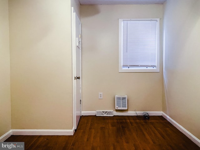 clothes washing area with dark wood-type flooring