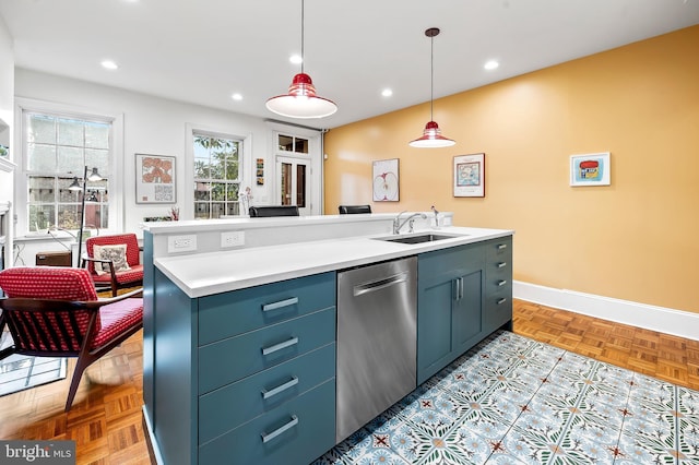 kitchen with decorative light fixtures, sink, stainless steel dishwasher, light parquet flooring, and a center island with sink