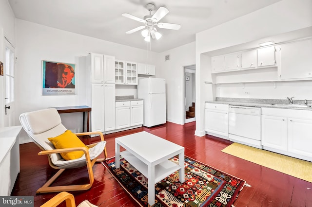 living room featuring dark wood-type flooring, ceiling fan, and sink