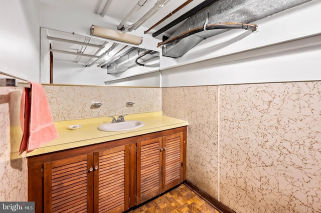 bathroom with vanity and parquet floors