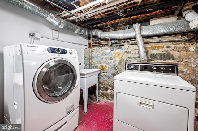 laundry room with washing machine and clothes dryer