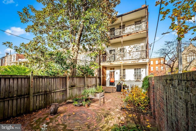 back of property with a patio area and a balcony