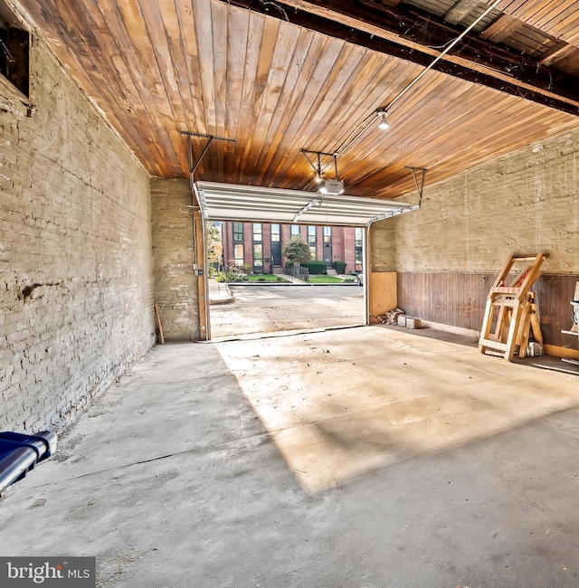 garage featuring a garage door opener and wooden ceiling