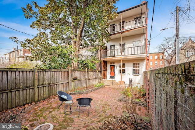 back of house featuring a patio and a balcony