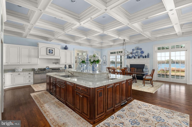 kitchen featuring coffered ceiling, a wealth of natural light, dark wood-type flooring, and a chandelier