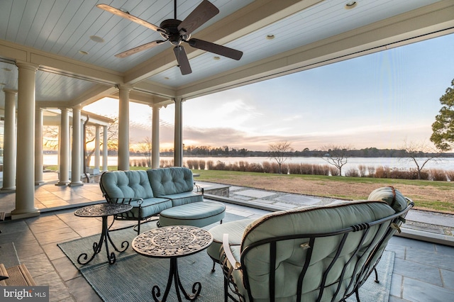 sunroom / solarium with ceiling fan, decorative columns, and beamed ceiling