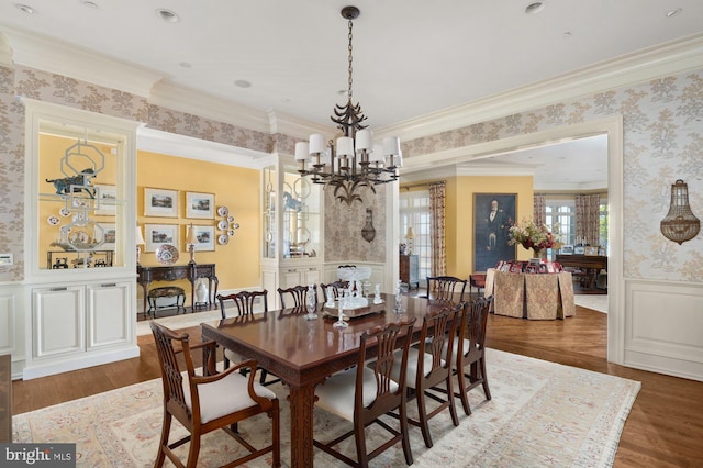 dining area with ornamental molding, dark hardwood / wood-style floors, and a chandelier