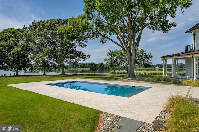 view of swimming pool with a lawn and a patio