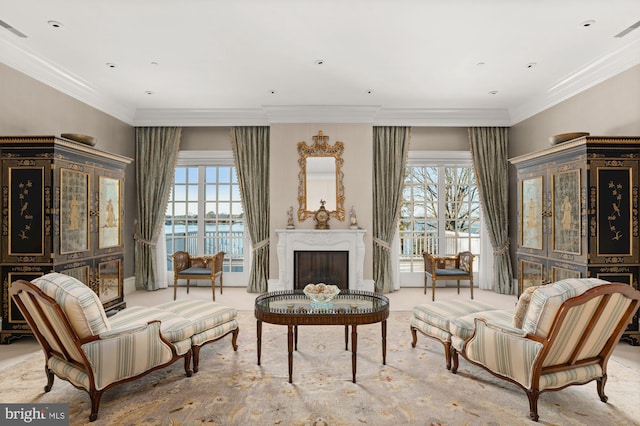 living area with light carpet, a water view, and a healthy amount of sunlight