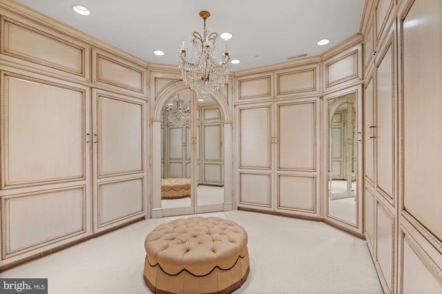 spacious closet with a notable chandelier and light colored carpet