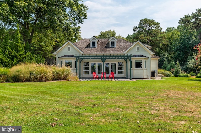 view of front of property featuring a front lawn and a patio